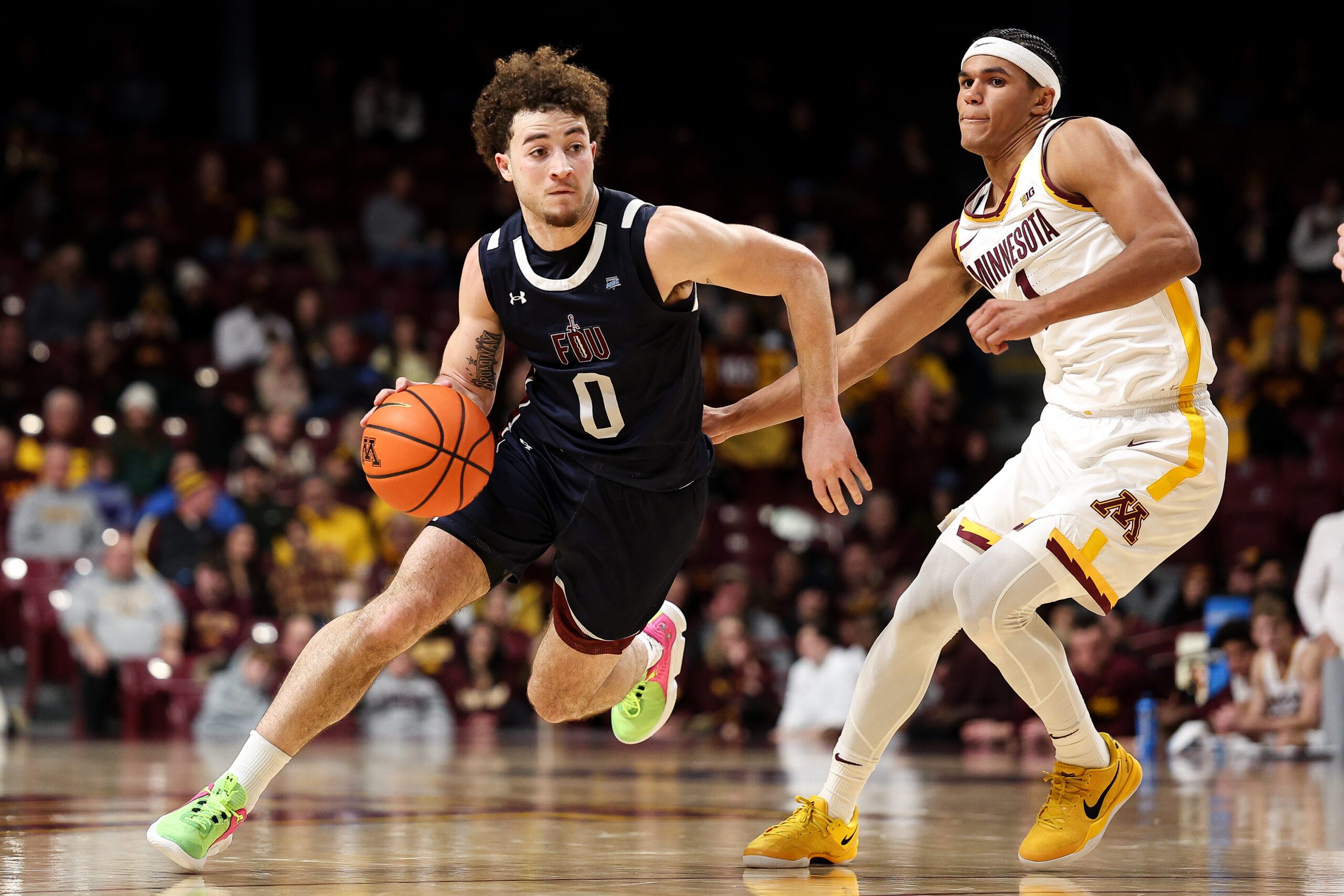 Dec 29, 2025; Minneapolis, Minnesota, USA; Fairleigh Dickinson Knights guard Joey Niesman (0) works around Minnesota Golden Gophers guard Isaac Asuma (1) during the second half at Williams Arena. Mandatory Credit: Matt Krohn-Imagn Images