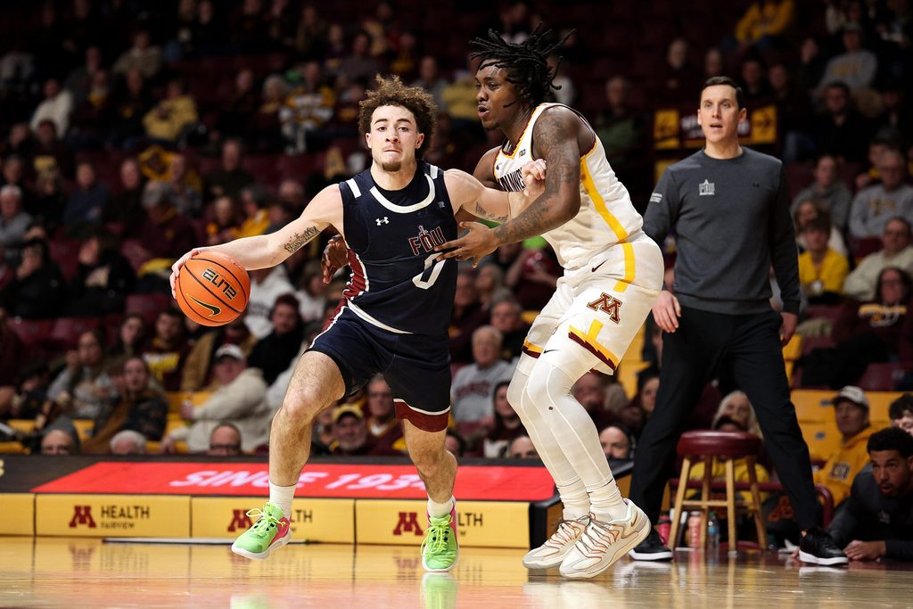 Dec 29, 2025; Minneapolis, Minnesota, USA; Fairleigh Dickinson Knights guard Joey Niesman (0) works around Minnesota Golden Gophers guard Langston Reynolds (6) during the second half at Williams Arena. Mandatory Credit: Matt Krohn-Imagn Images