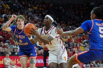 Iowa State Cyclones forward Killyan Toure (27) drives with the ball to the basket between Houston Christian Huskies forward Trent Johnson (8) and guard D'Aundre Samuels (5) during the first half in the NCAA men’s basketball on Dec. 29. 2025, at Hilton Coliseum in Ames, Iowa.