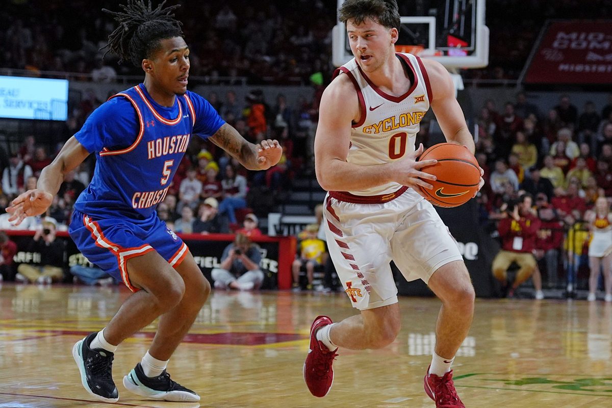 Iowa State Cyclones guard Nate Heise (0) drives with the ball around Houston Christian Huskies guard D'Aundre Samuels (5) during the first half in the NCAA men’s basketball on Dec. 29. 2025, at Hilton Coliseum in Ames, Iowa.