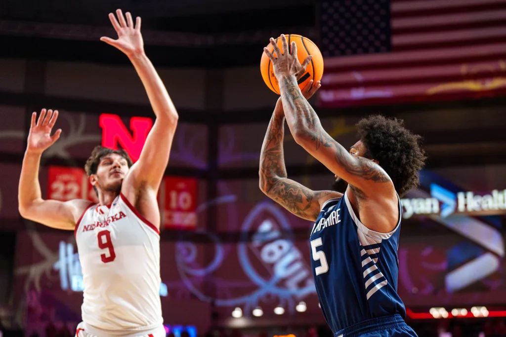 Dec 30, 2025; Lincoln, Nebraska, USA; New Hampshire Wildcats guard R.J. Kennedy (5) shoots against Nebraska Cornhuskers forward Berke Buyuktuncel (9) during the second half at Pinnacle Bank Arena. Mandatory Credit: Dylan Widger-Imagn Images