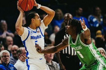 Memphis Tiger Curtis Givens III (5) looks to make a pass against North Texas’ David Terrell Jr. (5) during a game on Dec. 31, 2025 at the FedExForum in Memphis, Tenn.