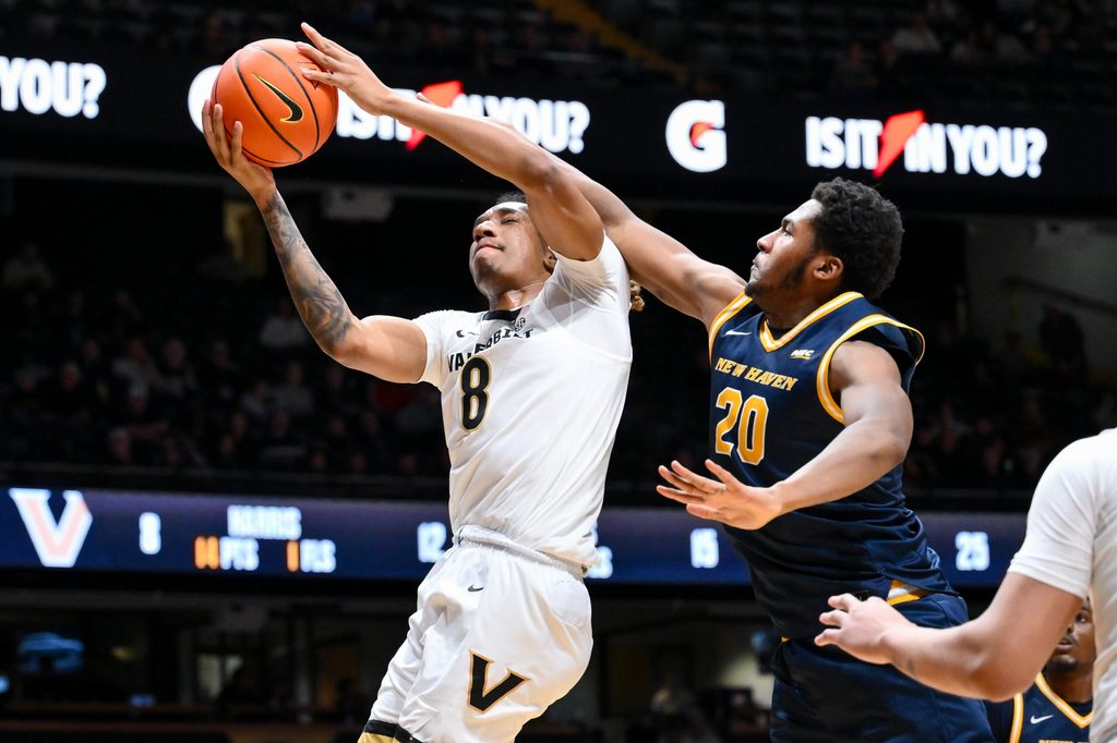 Dec 29, 2025; Nashville, Tennessee, USA; Vanderbilt Commodores guard Tyler Harris (8) lays the ball in over New Haven Chargers forward Tristian Burth (20) during the second half at Memorial Gymnasium. Mandatory Credit: Steve Roberts-Imagn Images