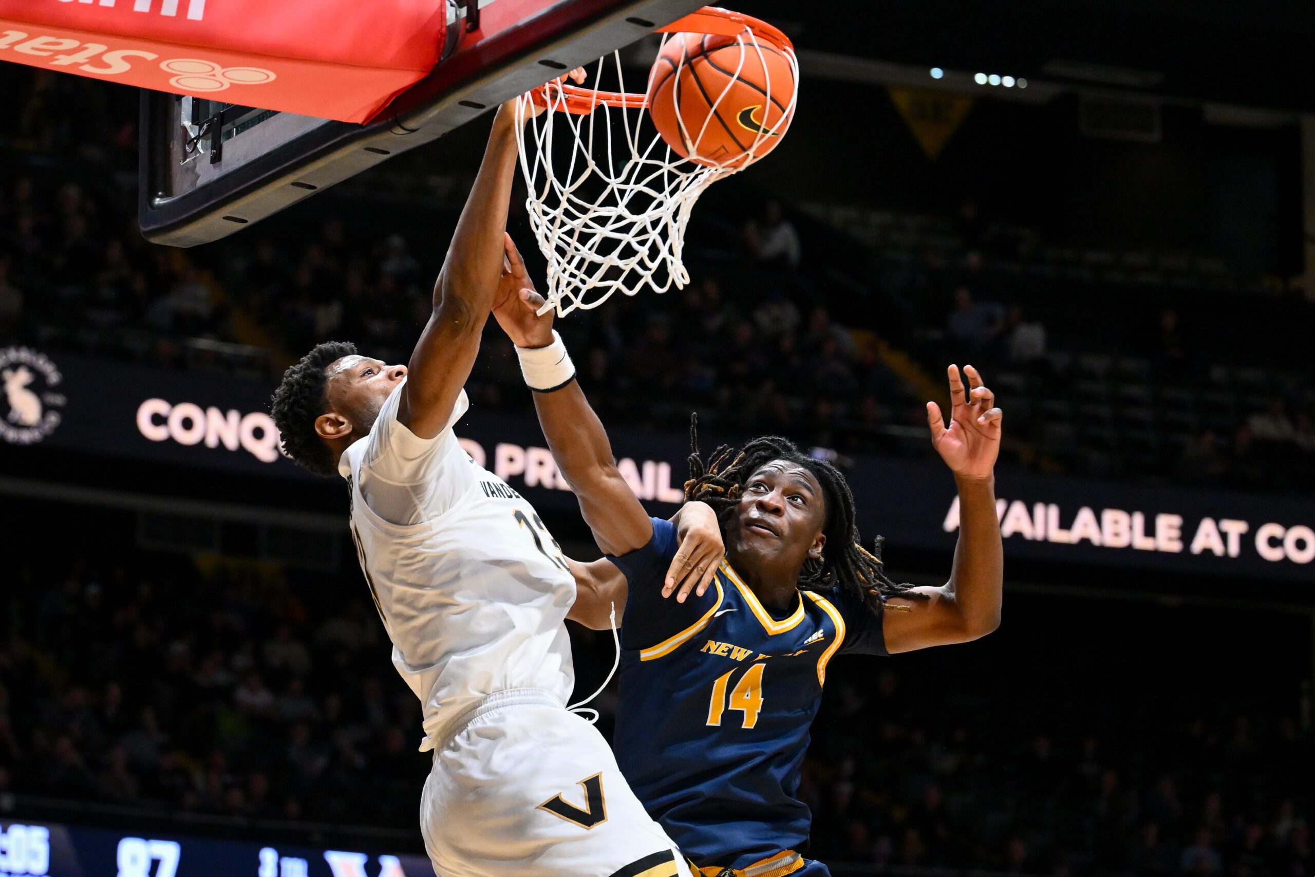 Dec 29, 2025; Nashville, Tennessee, USA;  Vanderbilt Commodores forward Jalen Washington (13) dunks the ball over New Haven Chargers guard Teshaun Steele (14) during the second half at Memorial Gymnasium. Mandatory Credit: Steve Roberts-Imagn Images