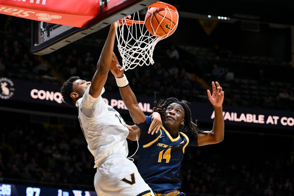 Dec 29, 2025; Nashville, Tennessee, USA; Vanderbilt Commodores forward Jalen Washington (13) dunks the ball over New Haven Chargers guard Teshaun Steele (14) during the second half at Memorial Gymnasium. Mandatory Credit: Steve Roberts-Imagn Images
