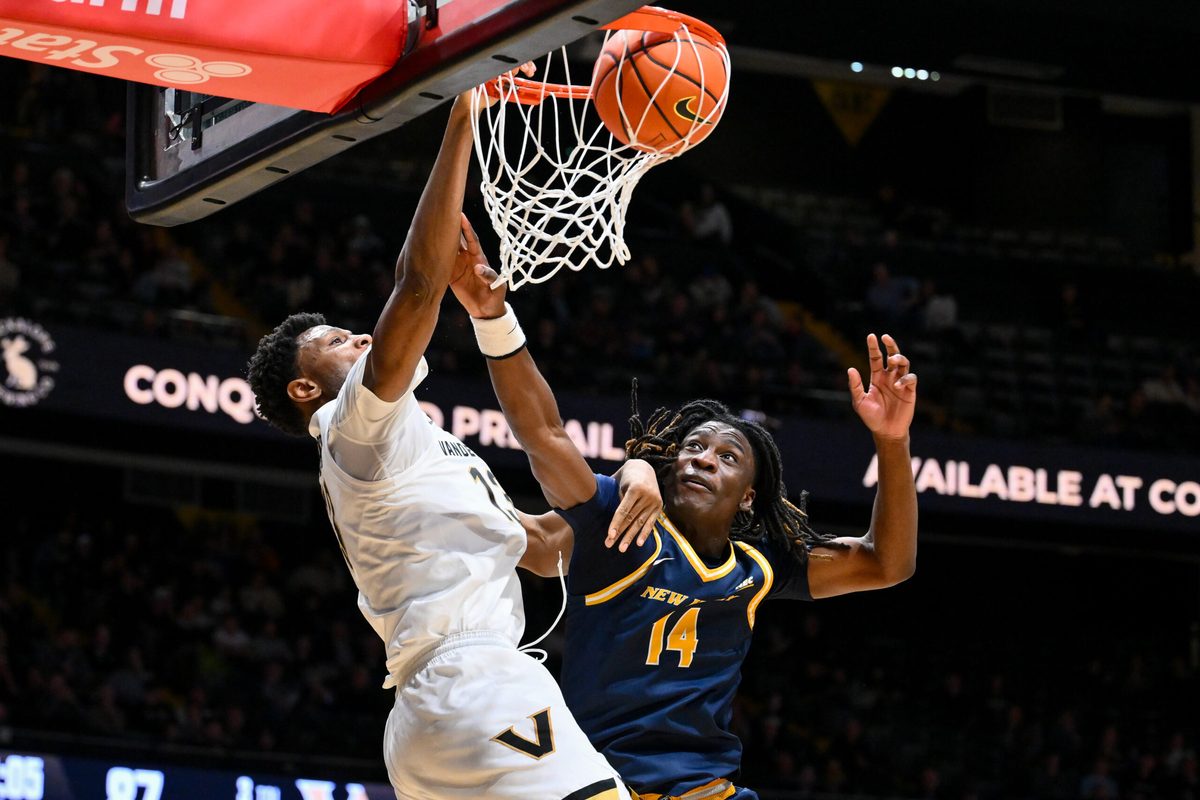 Dec 29, 2025; Nashville, Tennessee, USA; Vanderbilt Commodores forward Jalen Washington (13) dunks the ball over New Haven Chargers guard Teshaun Steele (14) during the second half at Memorial Gymnasium. Mandatory Credit: Steve Roberts-Imagn Images