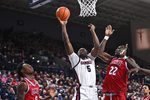 Jan 4, 2026; Spokane, Washington, USA; Gonzaga Bulldogs forward Emmanuel Innocenti (5) shoots the ball agaisnt Loyola Marymount Lions center Rick Issanza (22) in the second half at McCarthey Athletic Center. Mandatory Credit: James Snook-Imagn Images