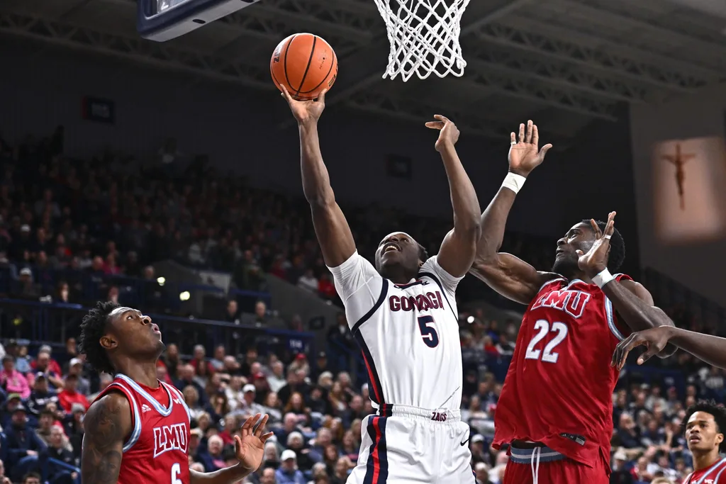 Jan 4, 2026; Spokane, Washington, USA; Gonzaga Bulldogs forward Emmanuel Innocenti (5) shoots the ball agaisnt Loyola Marymount Lions center Rick Issanza (22) in the second half at McCarthey Athletic Center. Mandatory Credit: James Snook-Imagn Images