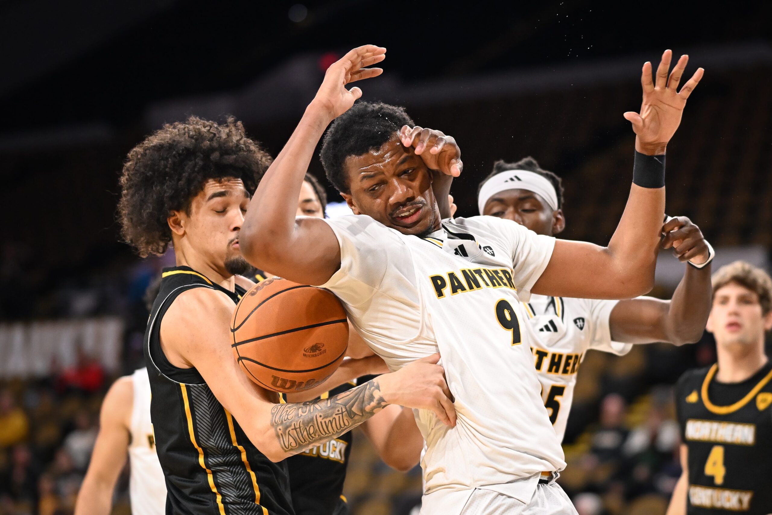 UW-Milwaukee forward Simeon Murchison (9) and Northern Kentucky forward Addison Archer (12) get tangled up fighting for a rebound in the second half Jan. 9 at the UWM Panther Arena.
