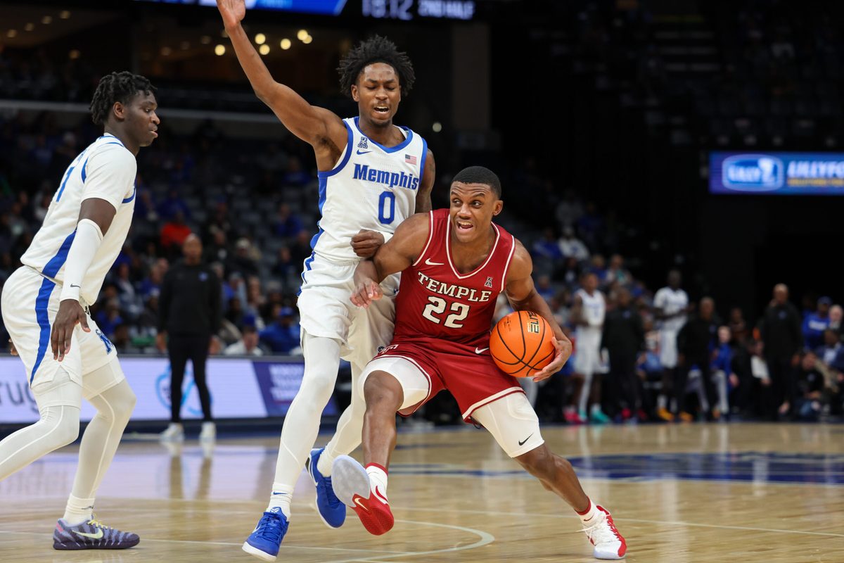Jan 14, 2026; Memphis, Tennessee, USA; Temple Owls guard Derrian Ford (22) drives against Memphis Tigers guard Quante Berry (0) during the second half at FedExForum. Mandatory Credit: Wesley Hale-Imagn Images