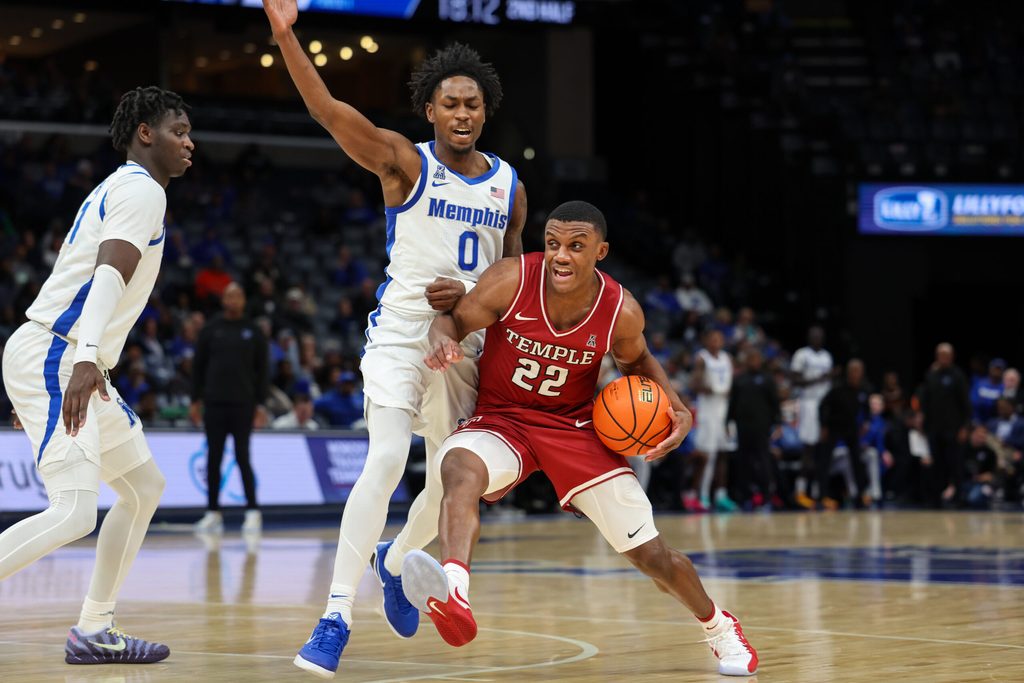 Jan 14, 2026; Memphis, Tennessee, USA; Temple Owls guard Derrian Ford (22) drives against Memphis Tigers guard Quante Berry (0) during the second half at FedExForum. Mandatory Credit: Wesley Hale-Imagn Images