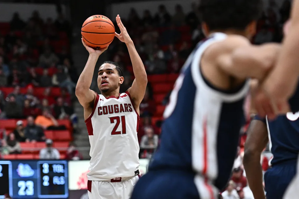 Jan 15, 2026; Pullman, Washington, USA; Washington State Cougars guard Ace Glass Lll (21) shoots a three-point basket against the Gonzaga Bulldogs in the first half at Friel Court at Beasley Coliseum. Mandatory Credit: James Snook-Imagn Images