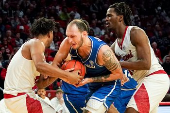 Miami (OH) RedHawks and Buffalo Bulls players battle for possession of the ball in the second half of a NCAA men’s basketball game between the Miami RedHawks and Buffalo Bulls, Saturday, Jan. 17, 2026, at Millett Hall in Oxford, Oh. RedHawks won 105-102.