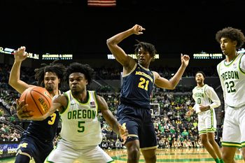 Jan 17, 2026; Eugene, Oregon, USA; Oregon Ducks guard Takai Simpkins (5) grabs a loose rebound in front of Michigan Wolverines guard Elliot Cadeau (3) and forward Morez Johnson Jr. (21) during the second half at Matthew Knight Arena. Mandatory Credit: Craig Strobeck-Imagn Images