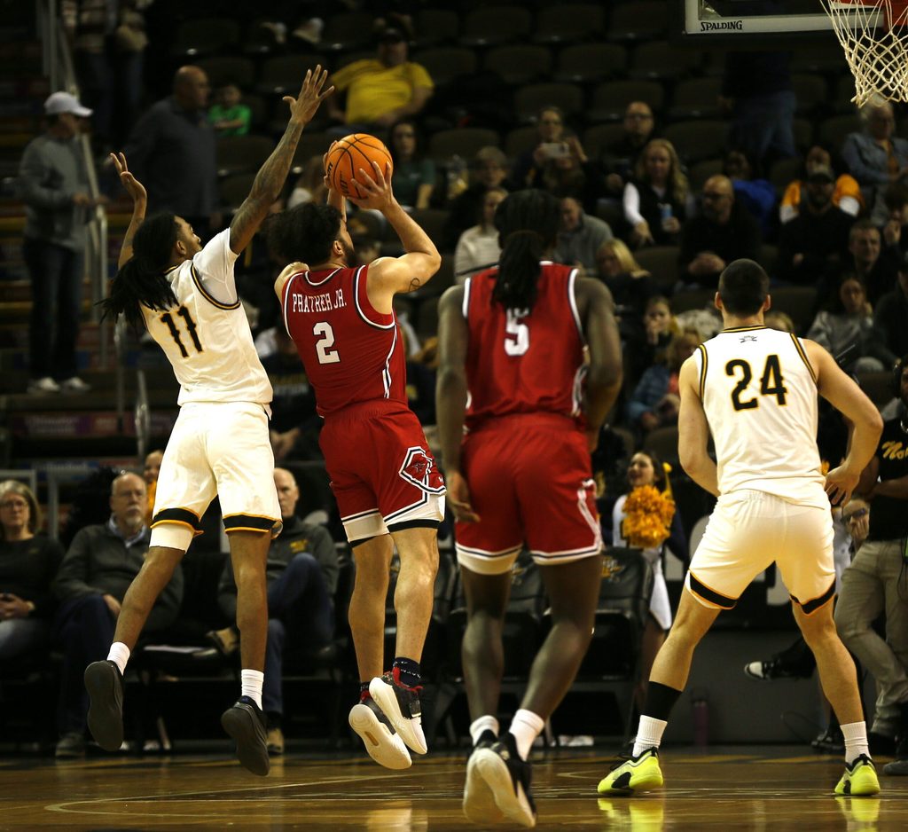 NKU's Tae Dozier (11) tries to block the shot of RMU's Ryan Prather (2) as NKU men's basketball lost 92-89 in overtime to Robert Morris Jan. 17, 2026 at Northern Kentucky University's Truist Arena.
