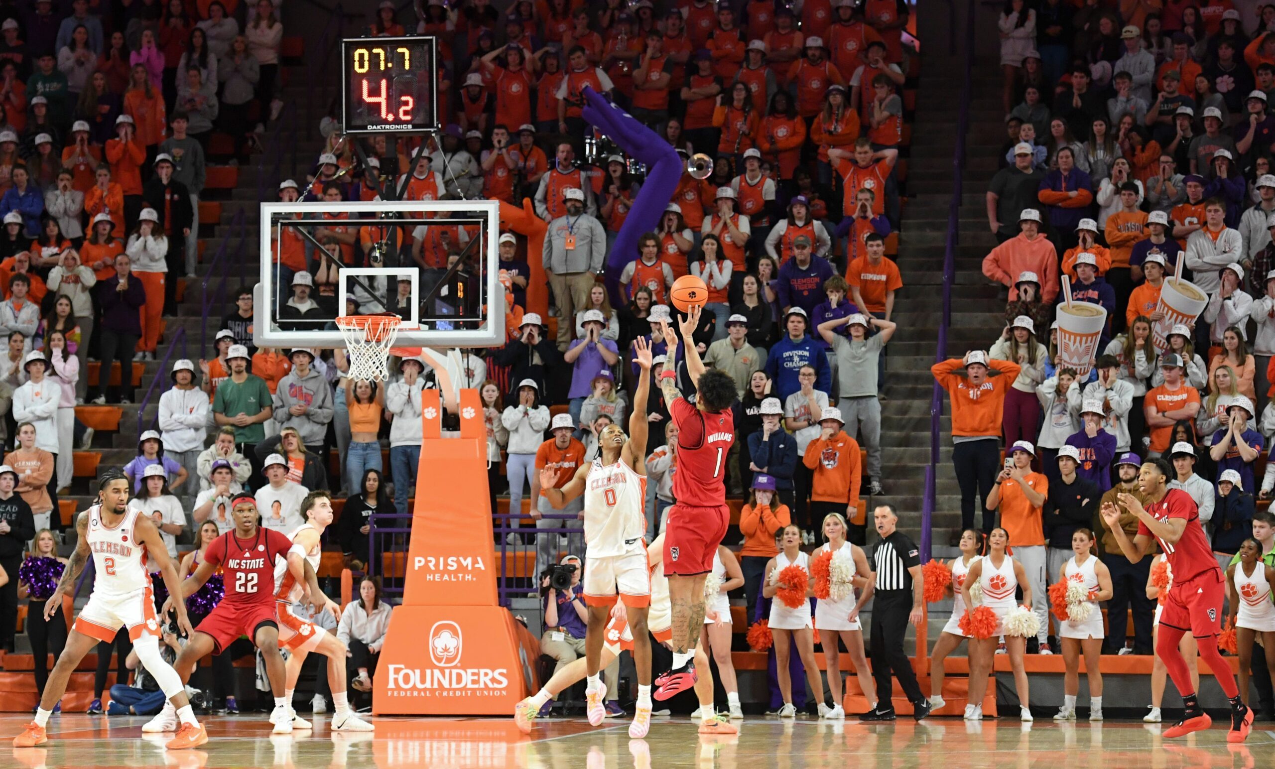 NC State Wolfpack forward Darrion Williams (1) shoots the ball past Clemson Tigers forward RJ Godfrey (0) with seven seconds left in the second half on Tuesday, Jan. 20, 2026, during the NCAA men’s basketball game at Littlejohn Coliseum in Clemson, South Carolina. NC State Wolfpack won 80-76 in OT.