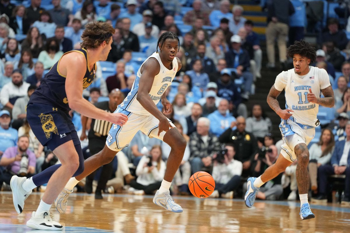 Jan 21, 2026; Chapel Hill, North Carolina, USA; North Carolina Tar Heels forward Caleb Wilson (8) brings the ball up the court as Notre Dame Fighting Irish forward Ryder Frost (7) defends in the second half at Dean E. Smith Center. Mandatory Credit: Bob Donnan-Imagn Images