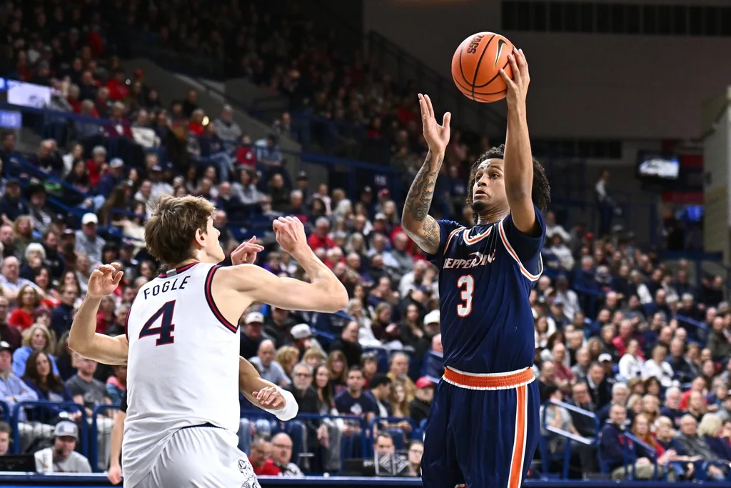 Jan 21, 2026; Spokane, Washington, USA; Pepperdine Waves guard Aaron Clark (3) shoots the ball against Gonzaga Bulldogs guard Davis Fogle (4) in the first half at McCarthey Athletic Center. Mandatory Credit: James Snook-Imagn Images