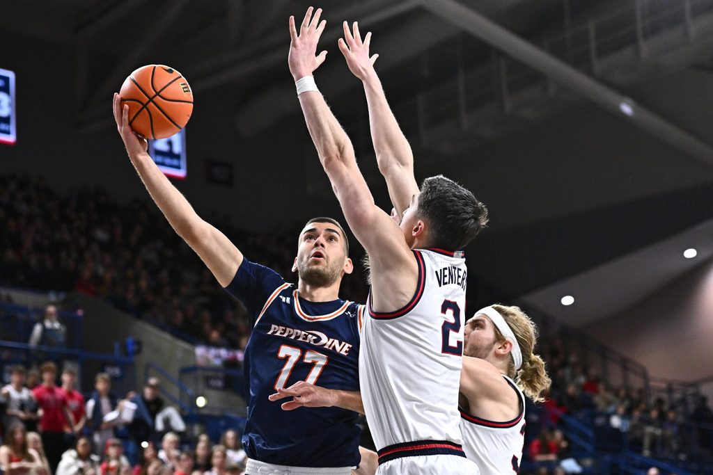 Jan 21, 2026; Spokane, Washington, USA; Pepperdine Waves guard Luka Vudragovic (77) shoots the ball against Gonzaga Bulldogs forward Steele Venters (2) in the second half at McCarthey Athletic Center. Mandatory Credit: James Snook-Imagn Images