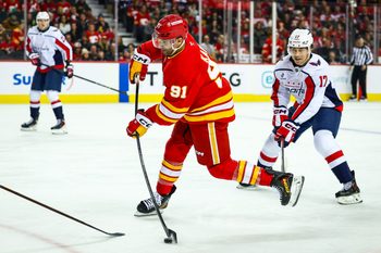 Jan 23, 2026; Calgary, Alberta, CAN; Calgary Flames center Nazem Kadri (91) shoots the puck against the Washington Capitals during the second period at Scotiabank Saddledome. Mandatory Credit: Sergei Belski-Imagn Images