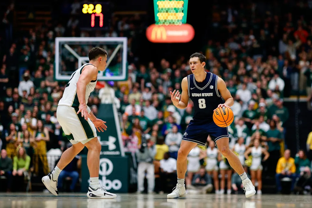 Jan 23, 2026; Fort Collins, Colorado, USA; Utah State Aggies guard Drake Allen (8) controls the ball as Colorado State Rams guard Brandon Rechsteiner (2) guards in the first half at Moby Arena. Mandatory Credit: Isaiah J. Downing-Imagn Images