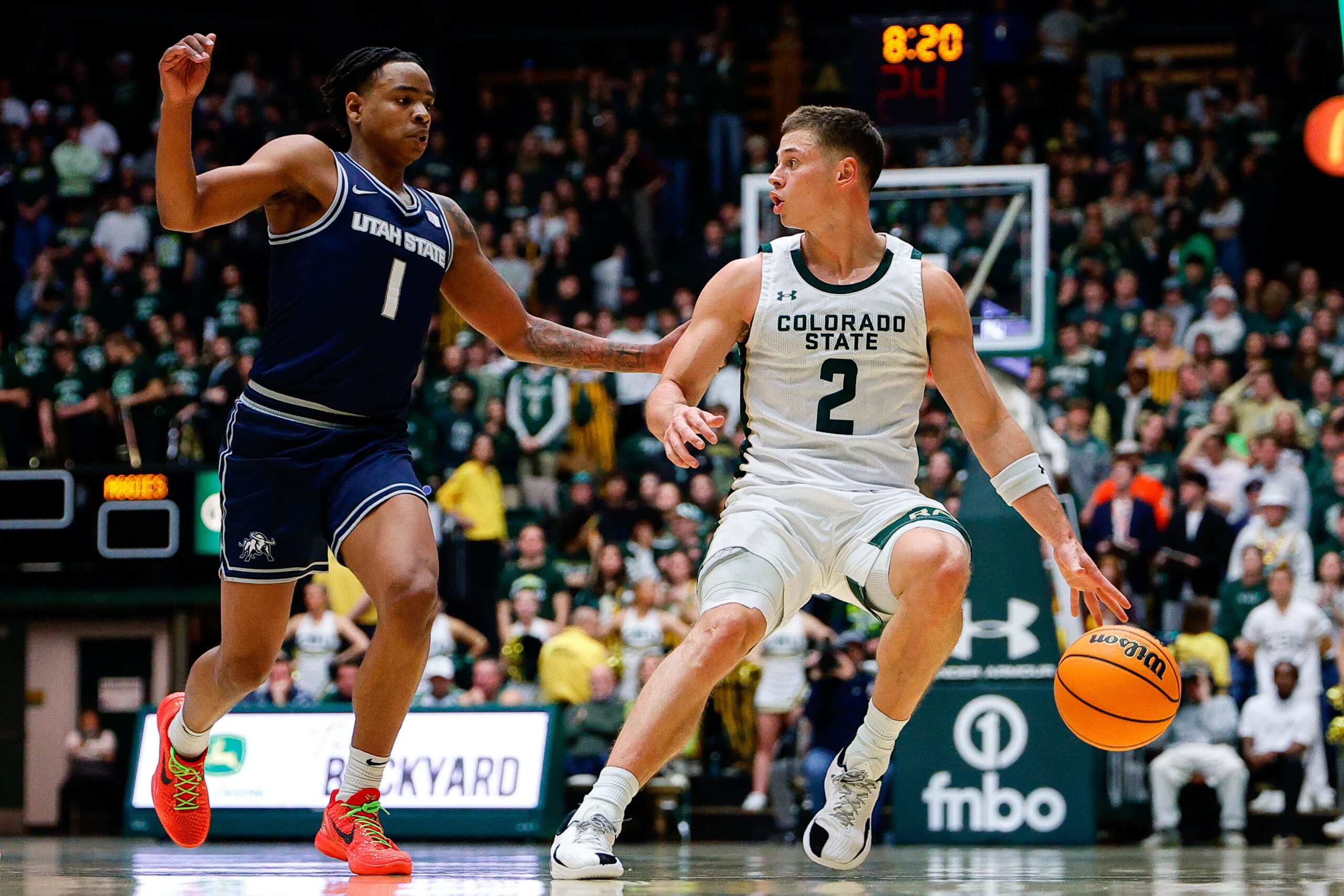 Jan 23, 2026; Fort Collins, Colorado, USA; Colorado State Rams guard Brandon Rechsteiner (2) controls the ball as Utah State Aggies guard Elijah Perryman (1) guards in the second half at Moby Arena. Mandatory Credit: Isaiah J. Downing-Imagn Images