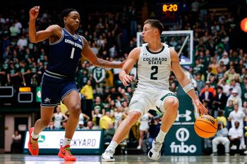 Jan 23, 2026; Fort Collins, Colorado, USA; Colorado State Rams guard Brandon Rechsteiner (2) controls the ball as Utah State Aggies guard Elijah Perryman (1) guards in the second half at Moby Arena. Mandatory Credit: Isaiah J. Downing-Imagn Images