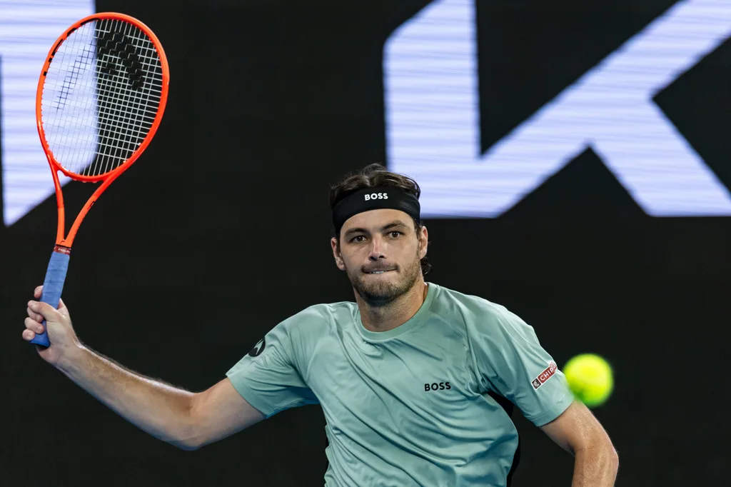 Jan 24, 2026; Melbourne, Victoria, Australia; Taylor Fritz of United States in action against Stan Wawrinka of Switzerland in the third round of the menís singles at the Australian Open at John Cain Arena in Melbourne Park. Mandatory Credit: Mike Frey-Imagn Images