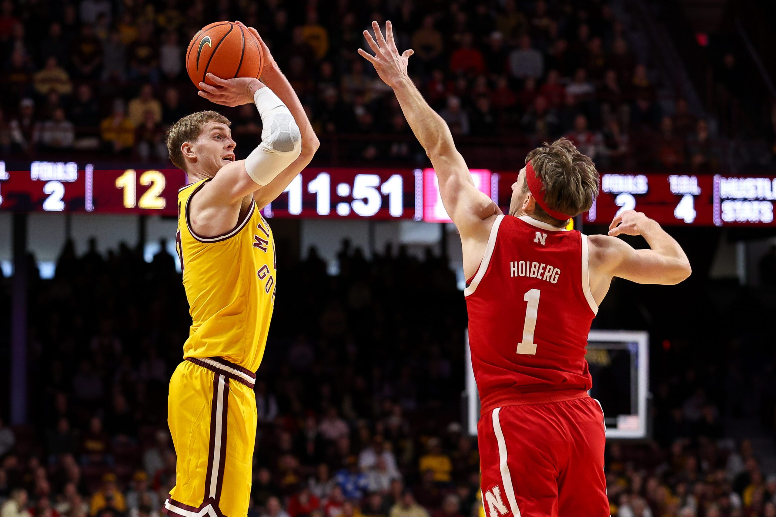 Jan 24, 2026; Minneapolis, Minnesota, USA; Minnesota Golden Gophers forward Cade Tyson (10) shoots over Nebraska Cornhuskers guard Sam Hoiberg (1) during the first half at Williams Arena. Mandatory Credit: Matt Krohn-Imagn Images