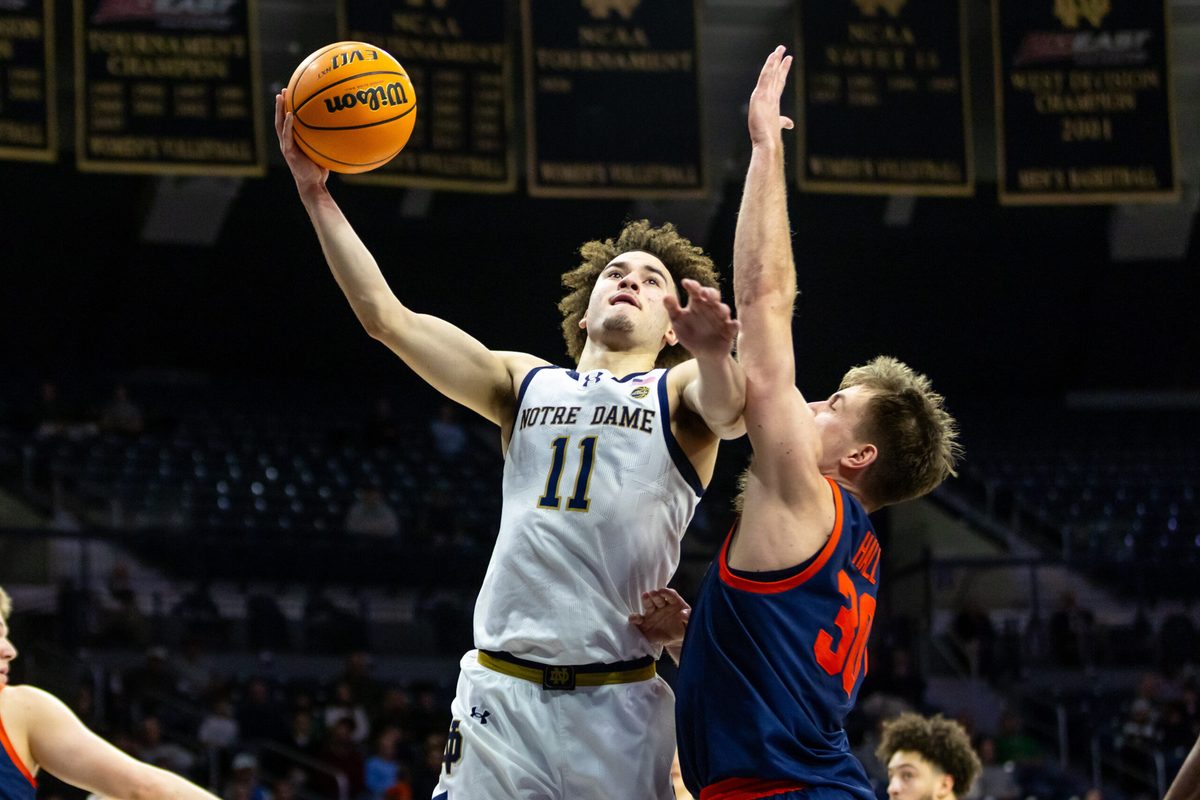 Jan 27, 2026; South Bend, Indiana, USA; Notre Dame Fighting Irish guard Braeden Shrewsberry (11) drives as Virginia Cavaliers guard Dallin Hall (30) defends during the first half at Purcell Pavilion at the Joyce Center. Mandatory Credit: Michael Caterina-Imagn Images