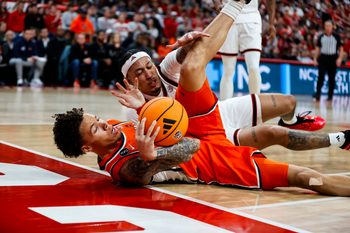 Jan 27, 2026; Raleigh, North Carolina, USA; NC State Wolfpack forward Darrion Williams (1) and Syracuse Orange guard Nate Kingz (4) react to the call during the second half of the game at Lenovo Center. Mandatory Credit: Jaylynn Nash-Imagn Images