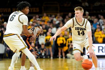 Iowa guard Bennett Stirtz (14) dribbles past Iowa’s Tavion Banks (6) as he screens USC guard Kam Woods (13) Jan. 28, 2026 at Carver-Hawkeye Arena in Iowa City, Iowa.