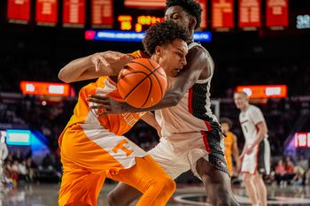 Jan 28, 2026; Athens, Georgia, USA; Tennessee Volunteers forward Nate Ament (10) tries to dribble past Georgia Bulldogs forward Kanon Catchings (6) during the second half at Stegeman Coliseum. Mandatory Credit: Dale Zanine-Imagn Images