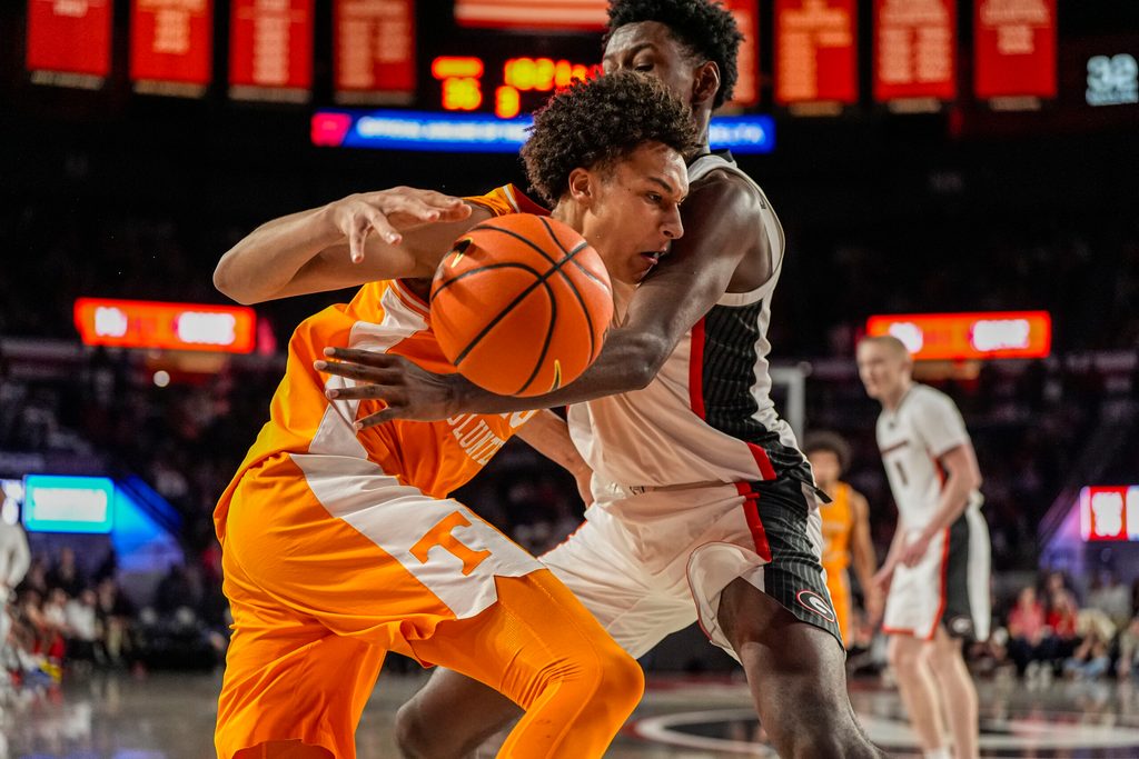 Jan 28, 2026; Athens, Georgia, USA; Tennessee Volunteers forward Nate Ament (10) tries to dribble past Georgia Bulldogs forward Kanon Catchings (6) during the second half at Stegeman Coliseum. Mandatory Credit: Dale Zanine-Imagn Images