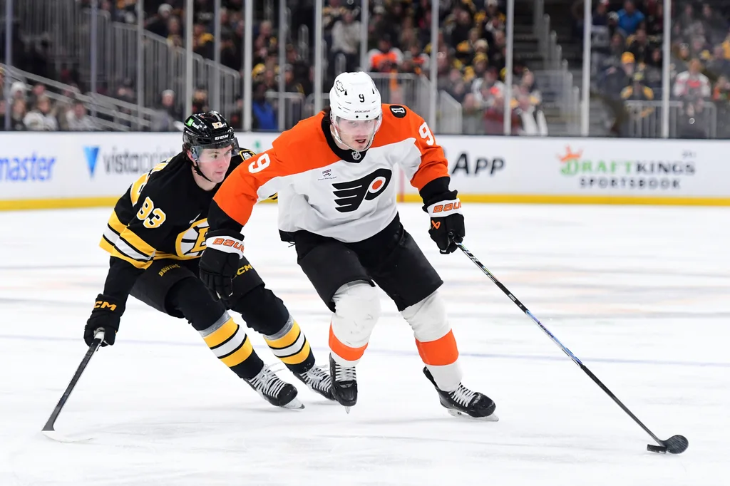 Jan 29, 2026; Boston, Massachusetts, USA; Philadelphia Flyers defenseman Jamie Drysdale (9) controls the puck from Boston Bruins center Fraser Minten (93) during the second period at TD Garden. Mandatory Credit: Bob DeChiara-Imagn Images