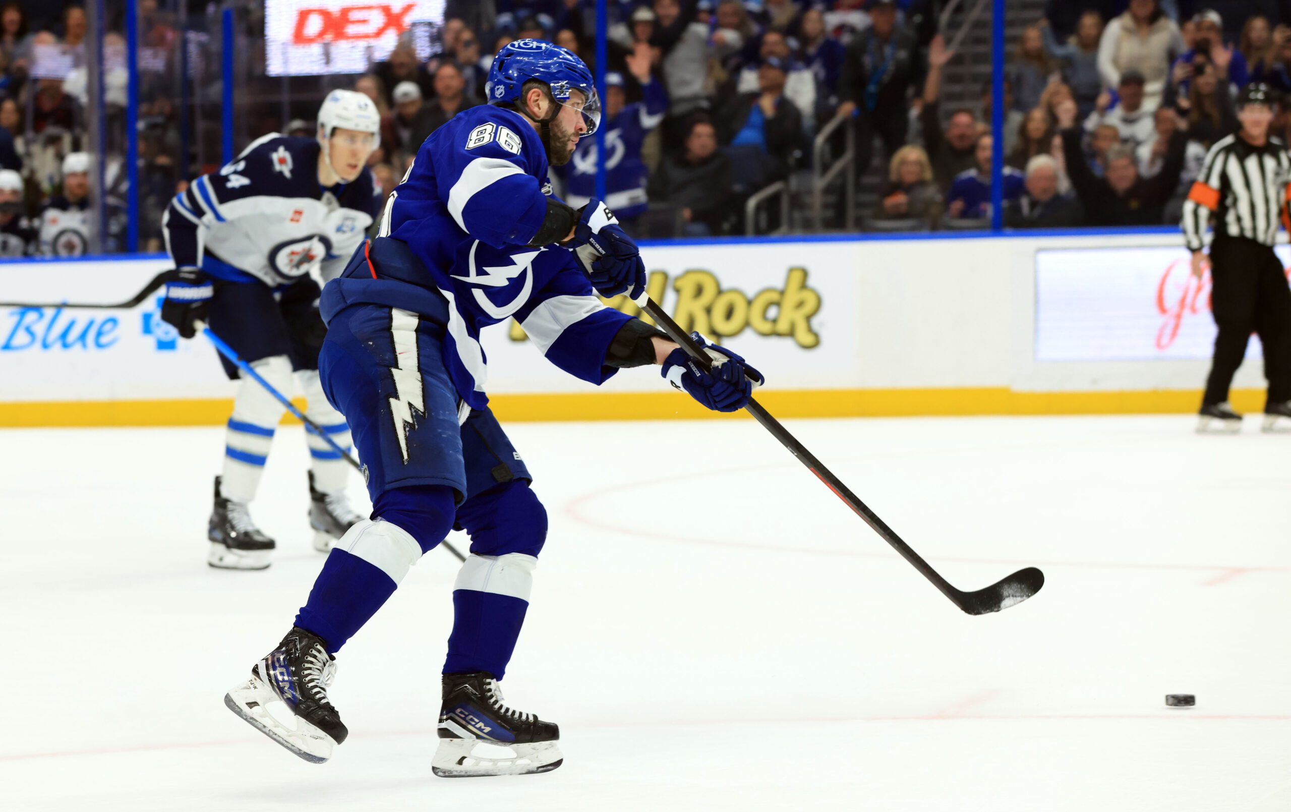 Jan 29, 2026; Tampa, Florida, USA; Tampa Bay Lightning right wing Nikita Kucherov (86) shoots and scores an empty net goal against the Winnipeg Jets during the third period at Benchmark International Arena. Mandatory Credit: Kim Klement Neitzel-Imagn Images