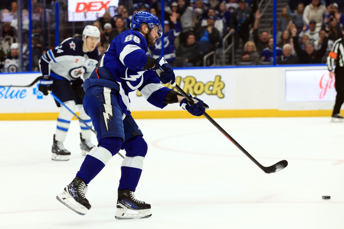Jan 29, 2026; Tampa, Florida, USA; Tampa Bay Lightning right wing Nikita Kucherov (86) shoots and scores an empty net goal against the Winnipeg Jets during the third period at Benchmark International Arena. Mandatory Credit: Kim Klement Neitzel-Imagn Images