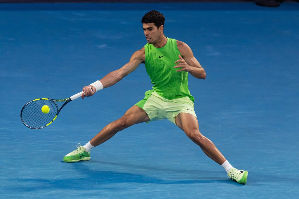 Jan 30, 2026; Melbourne, Victoria, Australia; Carlos Alcaraz of Spain in action against Alexander Zverev of Germany in the semifinals of the menís singles at the Australian Open at Rod Laver Arena in Melbourne Park. Mandatory Credit: Mike Frey-Imagn Images