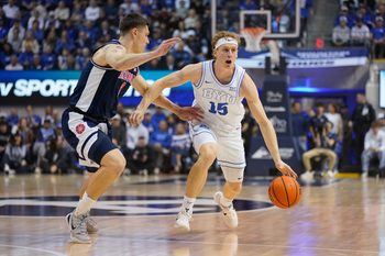 Jan 26, 2026; Provo, Utah, USA; BYU Cougars guard Richie Saunders (15) controls the ball while being defended by Arizona Wildcats forward Ivan Kharchenkov (8) during the first half at Marriott Center. Mandatory Credit: Aaron Baker-Imagn Images