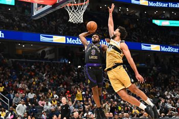Jan 30, 2026; Washington, District of Columbia, USA; Los Angeles Lakers guard Bronny James (9) is fouled by Washington Wizards forward Anthony Gill (16) during the second half at Capital One Arena. Mandatory Credit: Brad Mills-Imagn Images