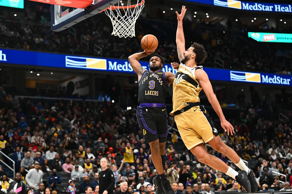 Jan 30, 2026; Washington, District of Columbia, USA; Los Angeles Lakers guard Bronny James (9) is fouled by Washington Wizards forward Anthony Gill (16) during the second half at Capital One Arena. Mandatory Credit: Brad Mills-Imagn Images