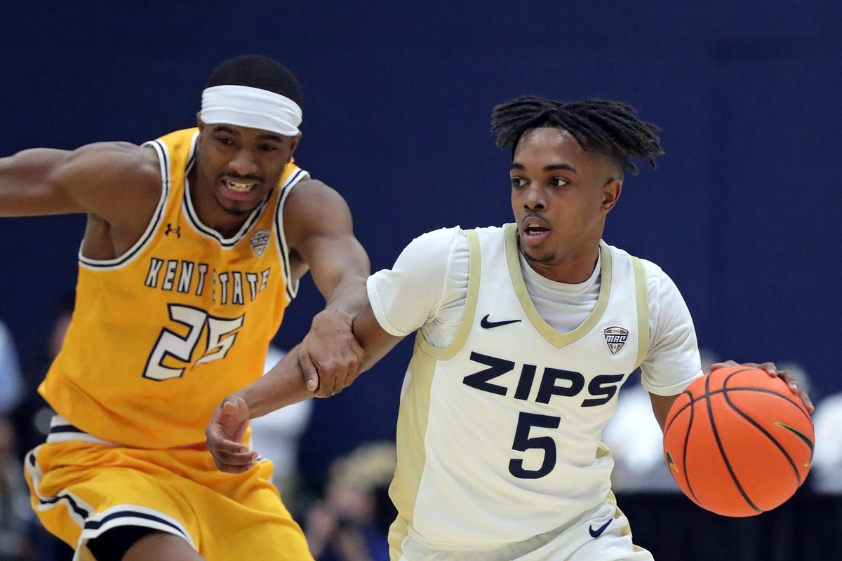 Akron Zips guard Tavari Johnson (5) moves past Kent State Golden Flashes guard Jahari Williamson (25) during the first half of an NCAA college basketball game at the JAR, Jan. 30, 2026, in Akron, Ohio.