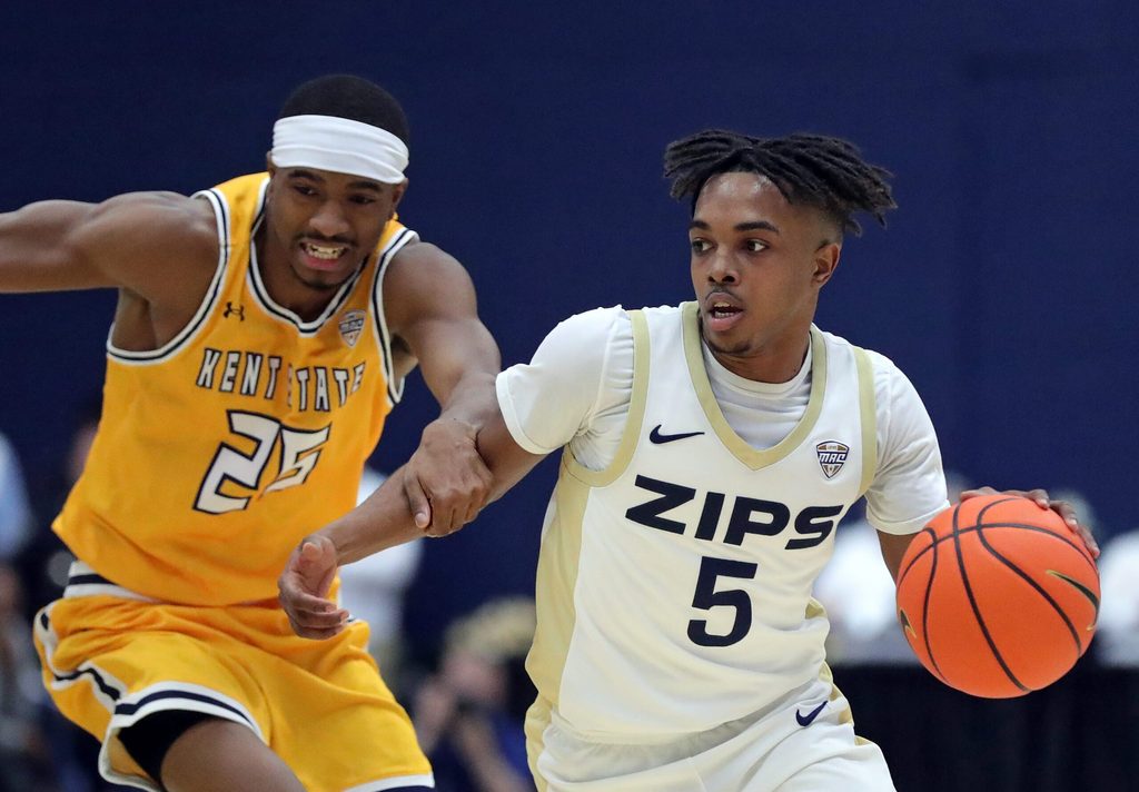 Akron Zips guard Tavari Johnson (5) moves past Kent State Golden Flashes guard Jahari Williamson (25) during the first half of an NCAA college basketball game at the JAR, Jan. 30, 2026, in Akron, Ohio.