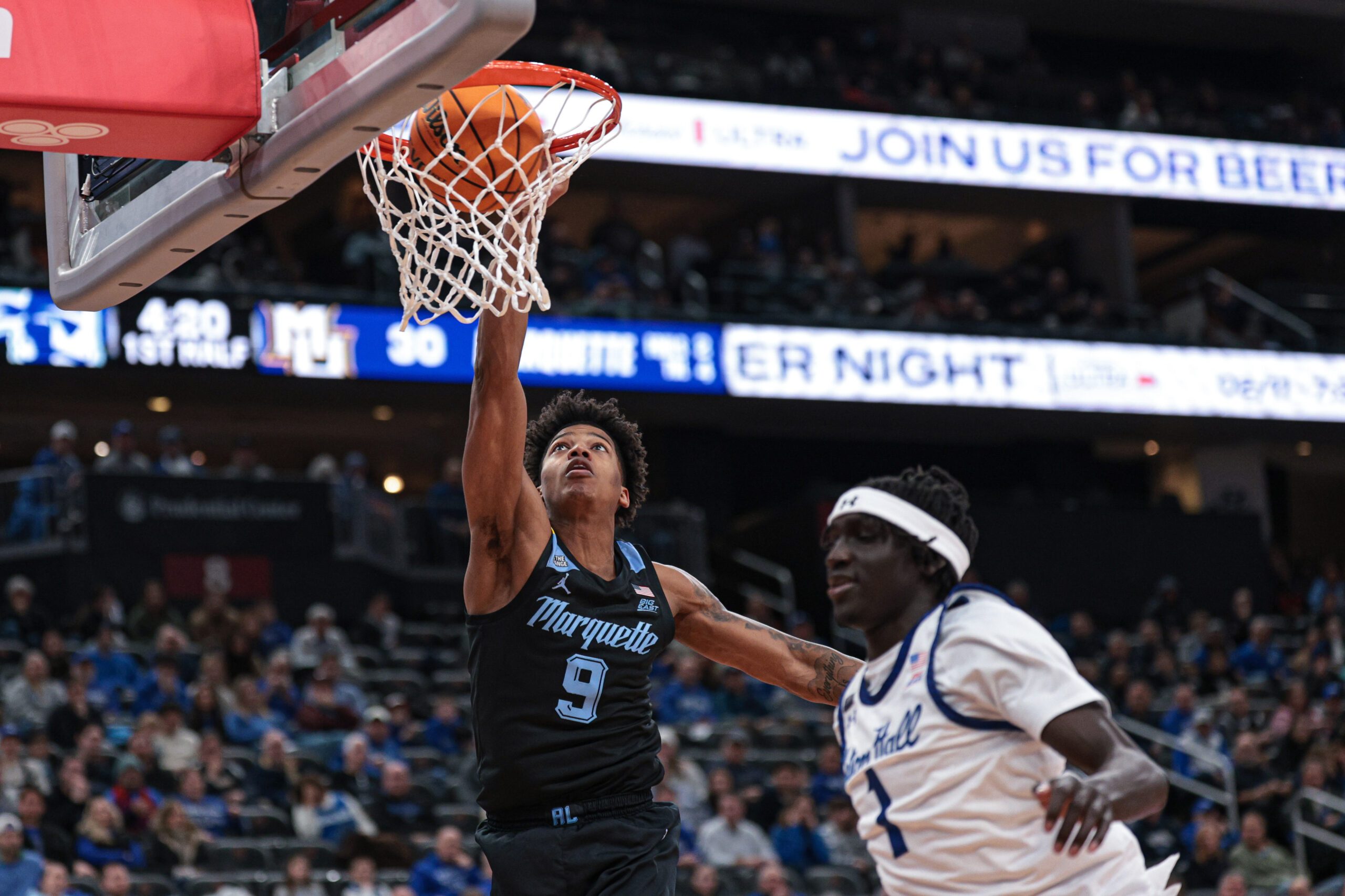 Jan 31, 2026; Newark, New Jersey, USA; Marquette Golden Eagles forward Damarius Owens (9) dunks the ball against Seton Hall Pirates forward Jacob Dar (1) during the first half at Prudential Center. Mandatory Credit: Vincent Carchietta-Imagn Images