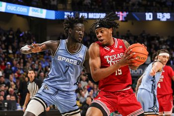 Jan 31, 2026; Orlando, Florida, USA; Texas Tech Red Raiders forward JT Toppin (15) drives against UCF Knights center John Bol (7) during the first half at Addition Financial Arena. Mandatory Credit: Mike Watters-Imagn Images