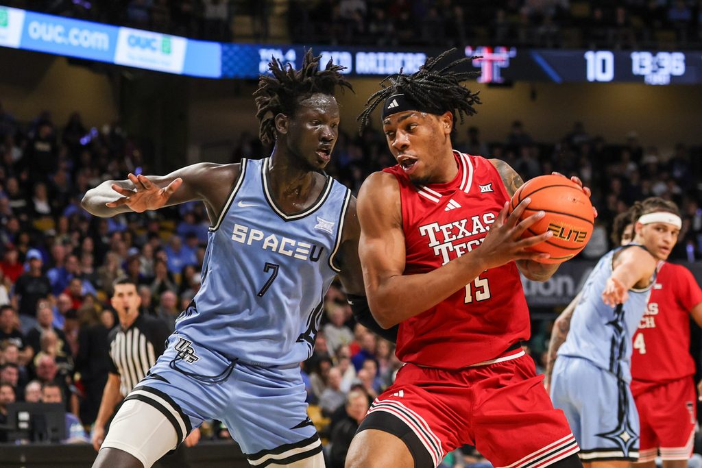Jan 31, 2026; Orlando, Florida, USA; Texas Tech Red Raiders forward JT Toppin (15) drives against UCF Knights center John Bol (7) during the first half at Addition Financial Arena. Mandatory Credit: Mike Watters-Imagn Images
