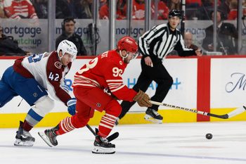 Jan 31, 2026; Detroit, Michigan, USA;  Detroit Red Wings right wing Alex DeBrincat (93) skates with the puck against Colorado Avalanche defenseman Josh Manson (42) in the first period at Little Caesars Arena. Mandatory Credit: Rick Osentoski-Imagn Images