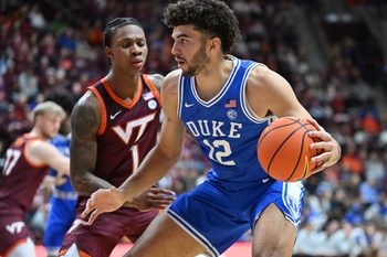 Jan 31, 2026; Blacksburg, Virginia, USA; Duke Blue Devils forward Cameron Boozer (12) works against Virginia Tech Hokies forward Tobi Lawal (1) during the first half at Cassell Coliseum. Mandatory Credit: Brian Bishop-Imagn Images