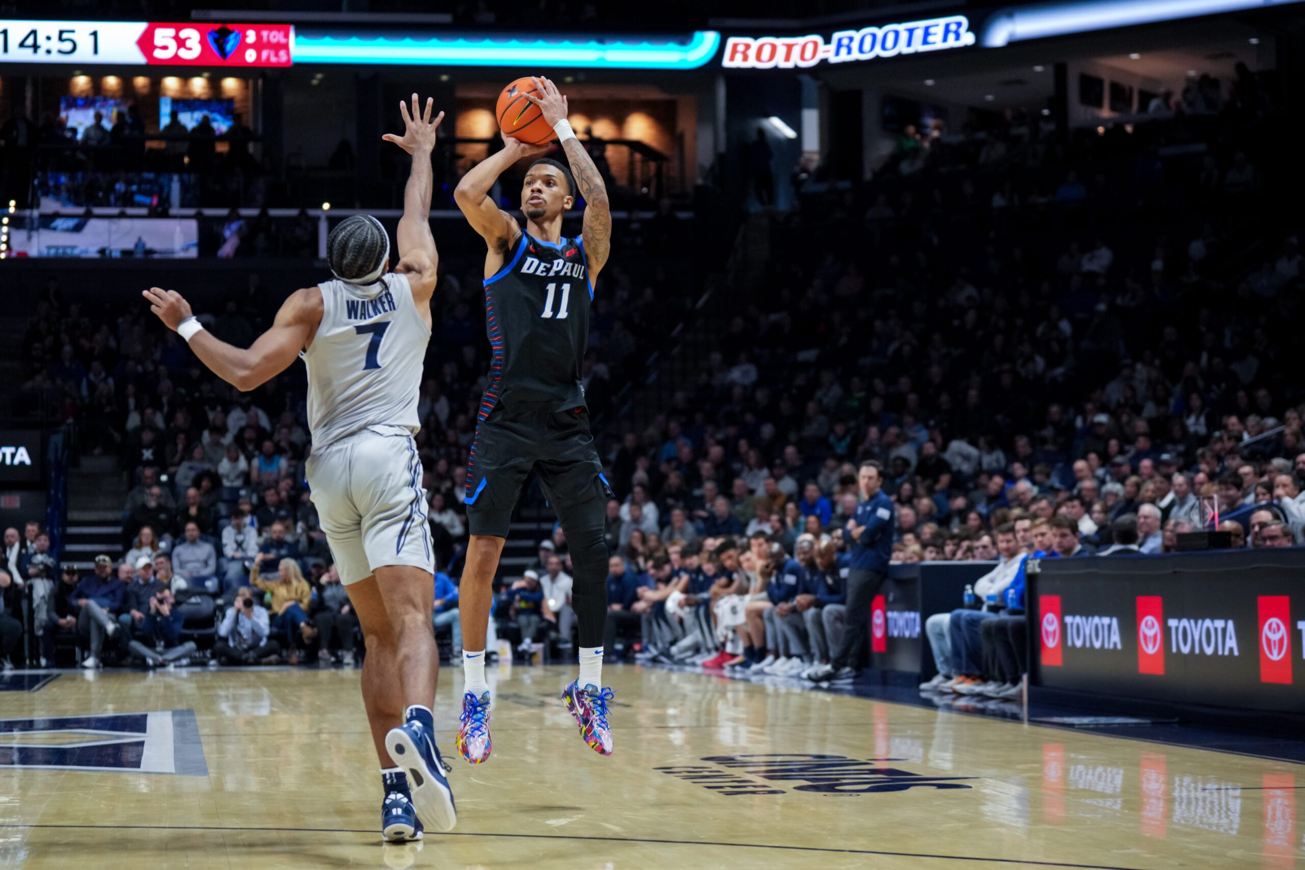 Jan 31, 2026; Cincinnati, Ohio, USA;  DePaul Blue Demons guard CJ Gunn (11) attempts a 3-point shot against Xavier Musketeers guard Isaiah Walker (7) in the second half at the Cintas Center. Mandatory Credit: Aaron Doster-Imagn Images