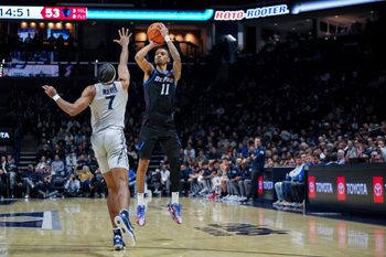 Jan 31, 2026; Cincinnati, Ohio, USA;  DePaul Blue Demons guard CJ Gunn (11) attempts a 3-point shot against Xavier Musketeers guard Isaiah Walker (7) in the second half at the Cintas Center. Mandatory Credit: Aaron Doster-Imagn Images